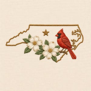 May include: An embroidery design featuring the outline of North Carolina in gold thread. Inside the border, a bright red cardinal bird sits on a branch next to two white dogwood flowers with green leaves and a small gold embroidered star.