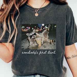 pepper funny aunt shirt raccoon iced coffee graphic, somebody’s feral aunt meme tee, sarcastic and trendy aunt gift