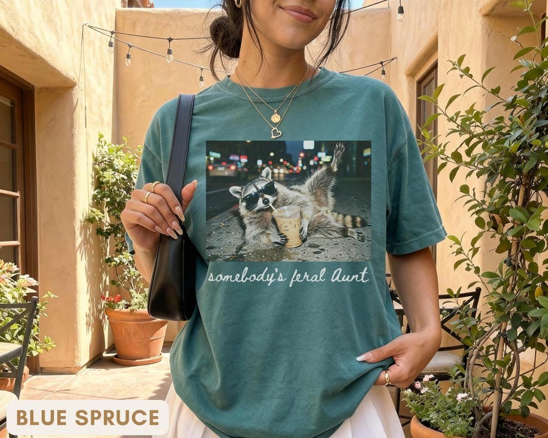 blue spruce funny aunt shirt with raccoon graphic, promoted to aunt pregnancy reveal shirt, stylish and modern aunt gift