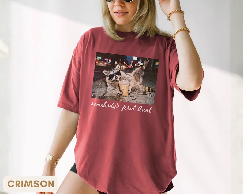 crimson funny aunt shirt with raccoon meme design, promoted to aunt announcement gift, bold and playful graphic tee