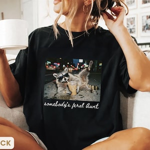 black weirdcore raccoon aunt shirt, funny somebody’s feral aunt graphic tee, edgy aesthetic meme shirt for cool aunt
