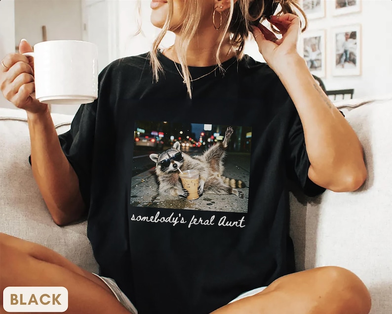 black weirdcore raccoon aunt shirt, funny somebody’s feral aunt graphic tee, edgy aesthetic meme shirt for cool aunt