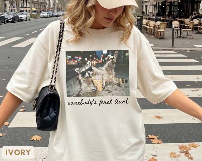 ivory raccoon meme shirt for aunt, funny somebody’s feral aunt tee with iced coffee design, unique gift for new aunt