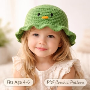 May include: A green crochet hat with a duck face design, featuring black eyes and an orange beak. The hat has a ruffled brim and is worn by a young child. The text "Fits Age 4-6" and "PDF Crochet Pattern" are visible.