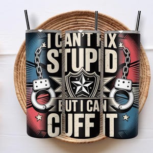 May include: A white ceramic mug with a black handle and the text "But First, Coffee" in a bold, black font. The mug is set against a blurred background, suggesting a cozy setting.