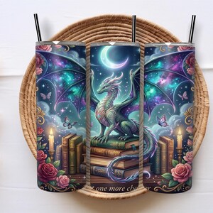 May include: A set of three stainless steel tumblers with black straws, featuring a fantasy design. The design includes a dragon, books, roses, butterflies, and a crescent moon against a starry background. Text on the bottom reads "one more chapter."