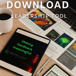 May include: A digital leadership tool with the text "INSTANT DOWNLOAD LEADERSHIP TOOL." A tablet displays "Making feedback meaningful." Papers and a laptop are on a wooden surface. A cup of coffee and a pen are also present.