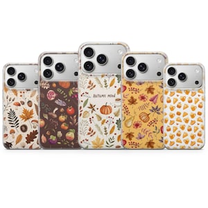 May include: Five smartphone cases featuring autumn-themed patterns. Designs include mushrooms, acorns, leaves, pumpkins, berries, and pie slices. The center case displays the text "Autumn mood" amidst a light background with various fall foliage and a pumpkin.