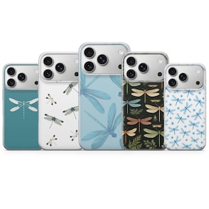 May include: Five phone cases with dragonfly designs. The cases feature various patterns, including teal, white, and blue backgrounds with dragonfly illustrations. One case has a dark background with dragonfly illustrations.