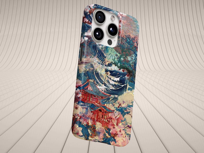 May include: A phone case featuring a colorful, artistic design. The case showcases a Japanese-inspired landscape with a red temple, blue water, and floral accents. The design is a blend of abstract and realistic elements.