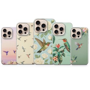 May include: A collection of five phone cases featuring hummingbird designs. The cases display various color palettes, including pastel pink, cream, and mint green. Each case showcases a unique hummingbird illustration with floral accents.