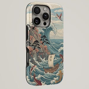 May include: A smartphone case featuring a detailed illustration of a large ocean wave, a wooden sailboat with a sail, several koi fish swimming in the water, a rocky cliff with trees, a small torii gate, and a bird flying in the cloudy sky.