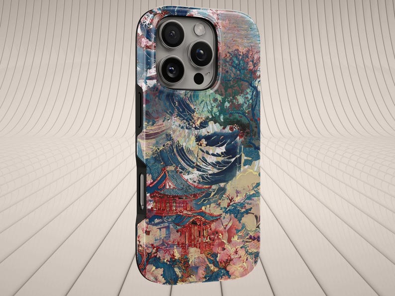May include: A phone case featuring an artistic design with a Japanese pagoda, cherry blossoms, and a mountain landscape. The case has a multi-camera system and a black border. The color palette includes shades of red, blue, and pink.