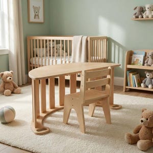 May include: A light wood children's table and chair set. The table has a curved design with vertical supports. The chair is simple with a slatted back. The room has a cot, bookshelf, and soft toys.