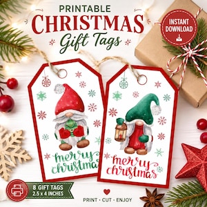 May include: Two rectangular white gift tags with red borders featuring watercolor gnomes. One gnome wears a red hat and holds a small tree; the other wears a green hat and holds a lantern. Both tags include the text Merry Christmas and snowflakes.