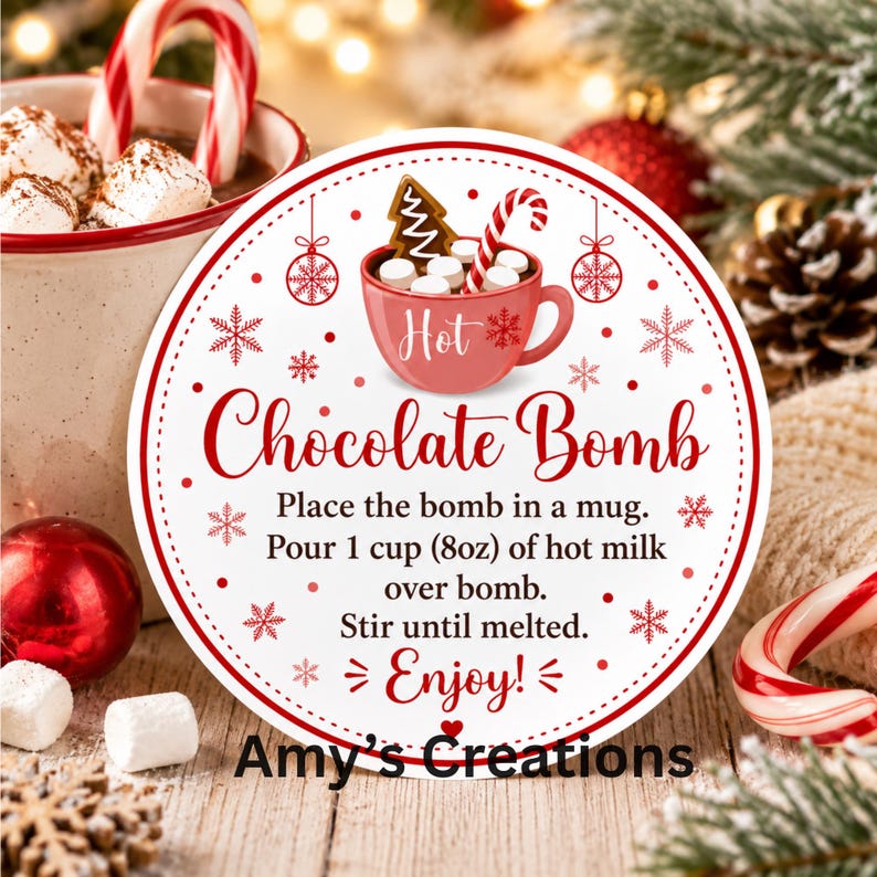 May include: A round white sticker with a red border featuring a red mug illustration with marshmallows, a candy cane, and a gingerbread tree. Text reads: Hot Chocolate Bomb, Place the bomb in a mug. Pour 1 cup (8oz) of hot milk over bomb. Stir until melted. Enjoy! Amy's Creations.