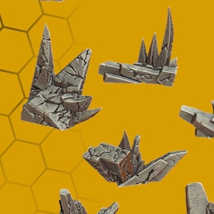May include: A collection of gray, jagged rock formations, possibly for tabletop gaming or model building. The pieces vary in size and shape, with sharp, pointed peaks and a textured, weathered appearance. The background is yellow and black with the words "BEE HAPPY".