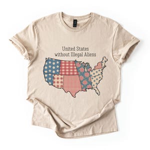 May include: A beige t-shirt featuring a patchwork design of the United States map in blue, red, and beige. The text "United States without Illegal Aliens" is printed above the map.