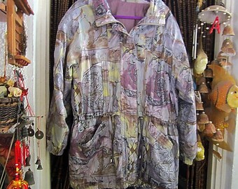 May include: A long-sleeved, abstract patterned jacket with a drawstring waist. The jacket is made of a silky material and has a purple lining. The jacket is a light purple, brown, and yellow color.
