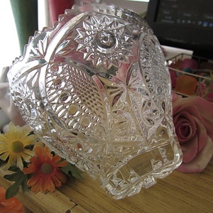 Peut inclure: Un bol en verre transparent avec un motif en verre taill&eacute;. Le bol a un bord festonn&eacute; et est d&eacute;cor&eacute; d'un motif r&eacute;p&eacute;titif de fleurs et de feuilles.