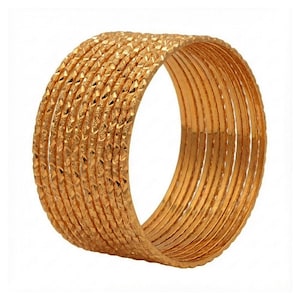 May include: A collection of gold-coloured bangles. Each bangle features a textured, diamond-shaped pattern. The set comprises numerous bangles, arranged together to create a layered appearance. The design is simple, yet elegant and refined.
