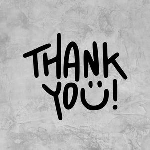May include: Black handwritten text on a gray textured background reads "THANK YOU!" The "O" in "YOU" is replaced with a smiley face. The text is in a bold, casual font.