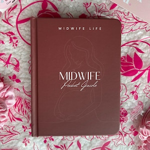 May include: A maroon-coloured "Midwife Pocket Guide" book with the text "Midwife Life" and an illustration of a pregnant person. The book is on a floral patterned surface with a "thank you" card and a sticker that says "Snap & Share!"