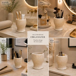 May include: A beige, marble-textured multipurpose organiser with a flared base and a wide, open top. This cylindrical container is shown in various settings, functioning as a toothbrush holder, makeup brush holder, pen holder, and small items holder.