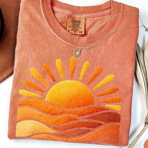 May include: A set of three ceramic mugs with a speckled, matte finish. The mugs are in shades of cream, light gray, and dark gray. Each mug has a simple, minimalist design, perfect for coffee or tea.