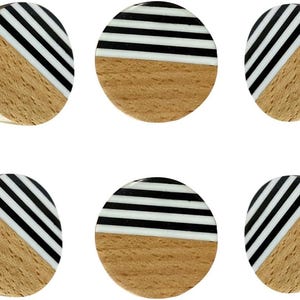 May include: A set of six circular cabinet knobs featuring a natural light brown wood grain on one half and a contrasting black and white striped pattern on the other half. Each knob includes a metal mounting screw extending from the back side.