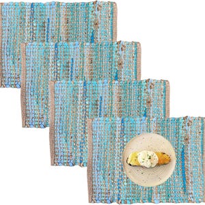 May include: A set of four rectangular placemats with a woven design in shades of blue and tan. One placemat has a plate with a piece of toast topped with an egg. The placemats have a textured appearance and a neutral border.