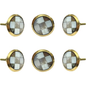 May include: Six decorative cabinet knobs with a checkerboard pattern. Each knob features a gold-colored metal base and a mosaic of white, gray, and brown squares. The knobs have a round shape and a small, gold-colored stem for attachment.