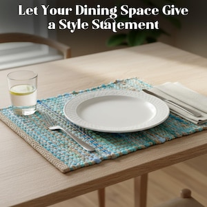May include: A dining table setting with a white plate, silverware, and a glass of water with lemon on a blue and beige placemat. The text at the top says, "Let Your Dining Space Give a Style Statement."