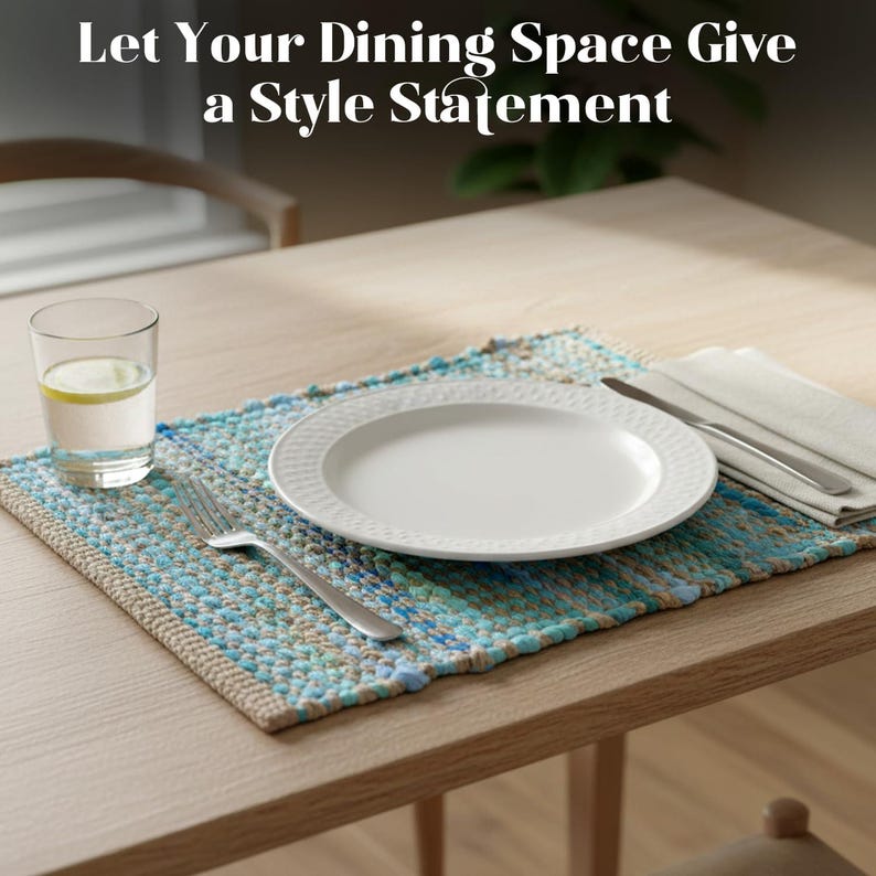 May include: A dining table setting with a white plate, silverware, and a glass of water with lemon on a blue and beige placemat. The text at the top says, "Let Your Dining Space Give a Style Statement."