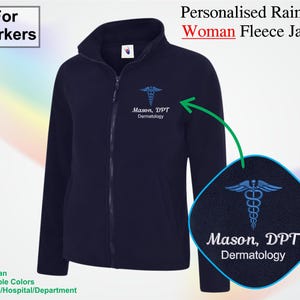 May include: Navy blue fleece jacket with a full zipper and a stand-up collar. The jacket features a medical symbol and the text "Mason, DPT Dermatology" in light blue. The text "For Workers" is in the top left corner.
