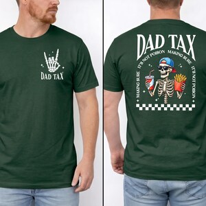 May include: Dark green t-shirt with the text "DAD TAX" and a skeleton hand gesture graphic. The back of the shirt features a skeleton with a drink and fries, the text "DAD TAX", and the phrase "MAKING SURE IT'S NOT POISON".