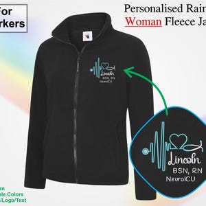 May include: Black fleece jacket with a full zip and a high collar. The jacket features a light blue graphic of a heartbeat and a heart with the text "Lincoln BSN, RN NeuroICU". The text "For Workers" is in the upper left corner.