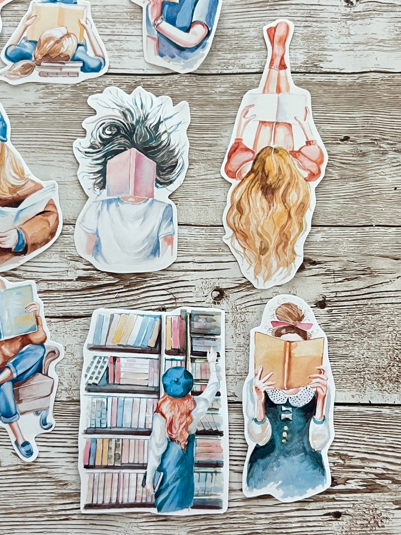 May include: A set of watercolor stickers featuring people reading books. The stickers are on a wooden background. The stickers are all different sizes and shapes. Some of the stickers feature people reading books with their faces covered by the book. Others feature people reading books with their faces visible. The stickers are all in a watercolor style and are very colorful.