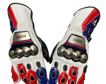 May include: White, red, and blue motorcycle gloves with the BMW and Motorrad logos. The gloves have protective knuckle armor and are made of leather. The design incorporates black accents and a sporty aesthetic.