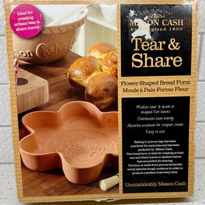 May include: A terracotta flower-shaped bread form from Mason Cash, with the text "Tear & Share". The form is designed for creating artisan tear and share loaves. The box also shows baked bread and a mixing bowl.