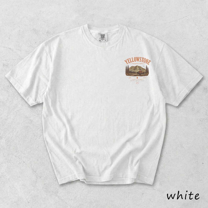May include: White t-shirt with a small graphic on the upper chest featuring the text "Yellowstone" above a mountain and tree scene. The word "white" is printed at the bottom right of the image.