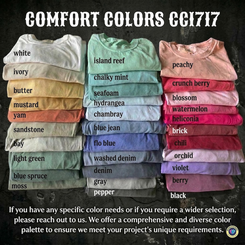 May include: Stacks of folded t-shirts in various colors, including white, ivory, butter, and mustard. The image displays a wide range of hues, from light greens to deep blacks, with each shirt labeled with its color name. The text "COMFORT COLORS CC1717" is at the top.