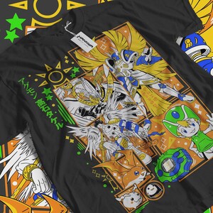 May include: Black t-shirt featuring a colorful anime-style graphic. The design includes characters with wings, armor, and a green-helmeted figure. The shirt has Japanese text and a tag that reads "HANNYA".