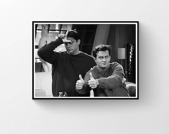 May include: Monochrome framed print showing two men. One is making a 'loser' sign, the other a thumbs up. The image is a still from the TV show Friends.