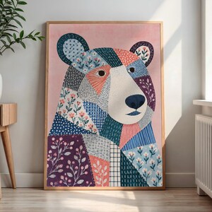 May include: A framed wall art print featuring a stylized bear portrait composed of various geometric patches. The bear is decorated with floral patterns, stripes, dots, and solid colors including pink, blue, white, and dark purple on a pink background.