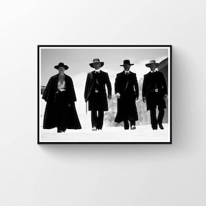 May include: A monochrome framed print showing four figures in long coats and hats, walking towards the viewer. The figures are dressed in period clothing, creating a dramatic and cinematic image.