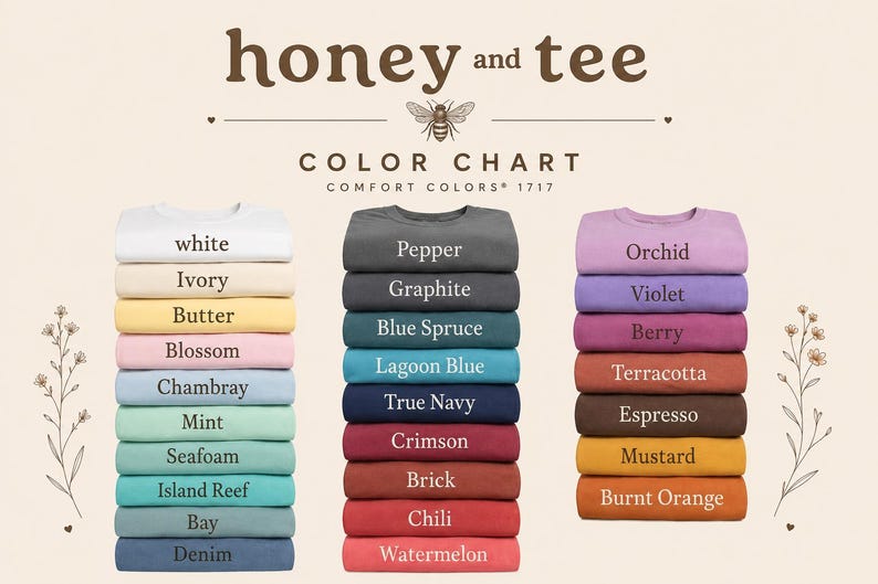 May include: A colour chart for Comfort Colors 1717 t-shirts by honey and tee, featuring three stacks of folded shirts in various colours. The text includes the brand name, colour chart, and labels for each shirt colour, such as white, pepper, and orchid.