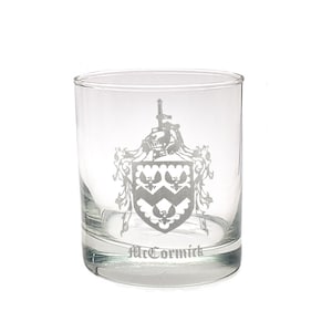 May include: A clear glass tumbler with a white etched design of a coat of arms and the name "McCormick".
