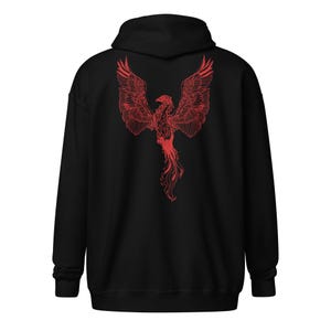 May include: Black hoodie featuring a red phoenix design on the back. The phoenix is depicted with outstretched wings and detailed feathering. The hoodie has a hood and long sleeves, suitable for casual wear.