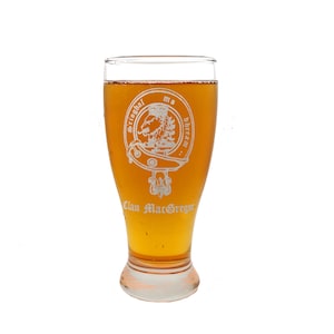 May include: A clear glass beer stein with a clan crest etched on the side. The crest features a lion, a shield, and the text "Srioghal mo dhreann Clan MacGregor".